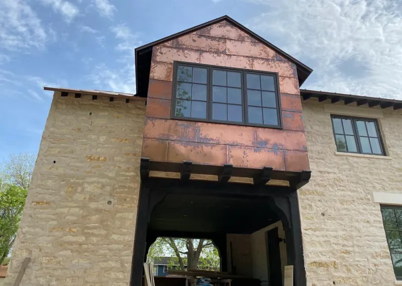 Copper metal panel facade on a stone building for Skylight Installation in Brownwood