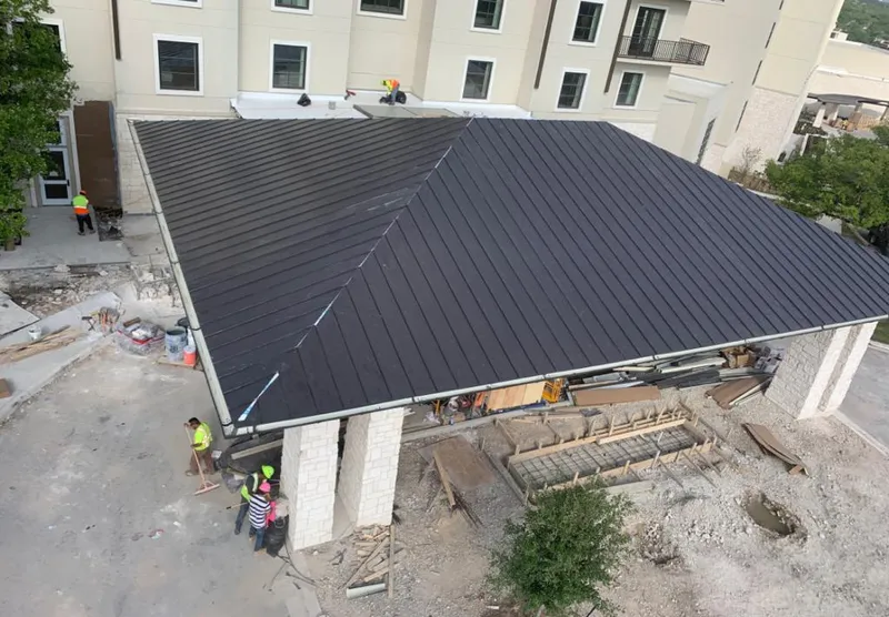Metal roofing installation team working on a commercial building in Brownwood